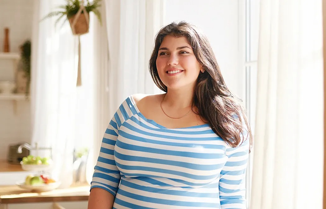 Happy patient at home starting her SlimBrisk weight loss treatment